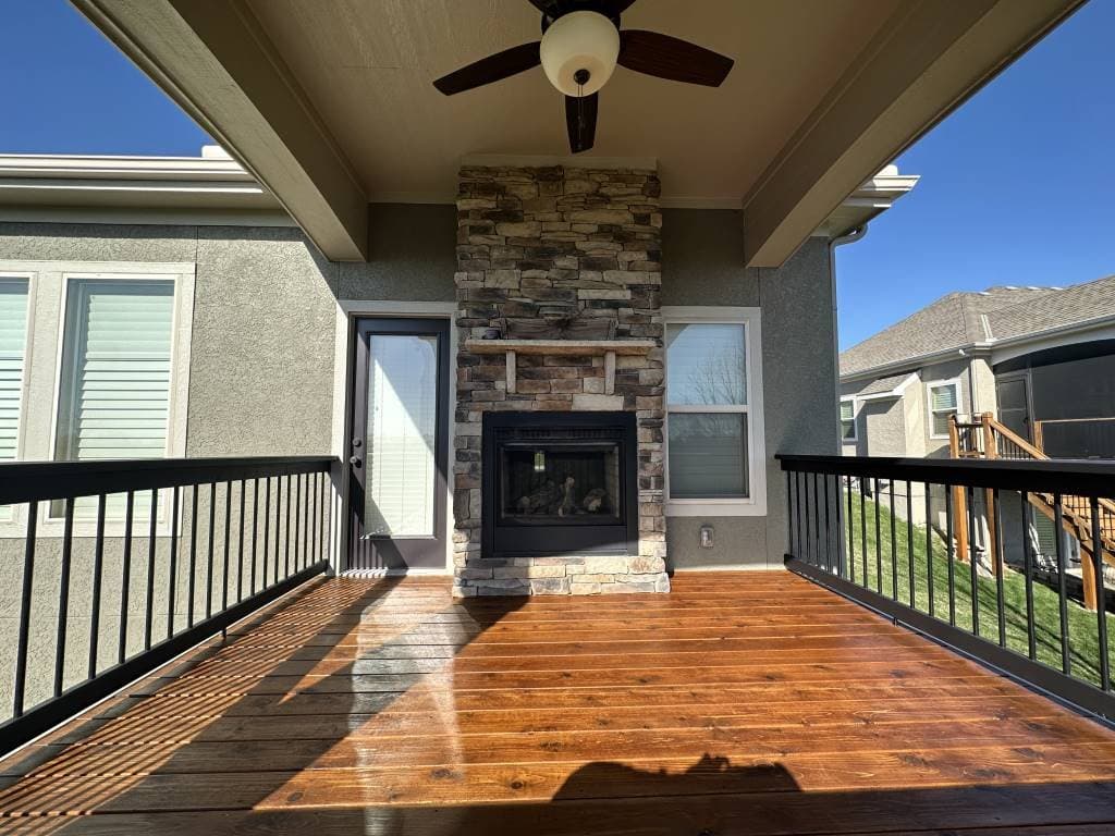 Freshly stained covered deck with stone fireplace